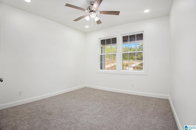 carpeted spare room featuring ceiling fan