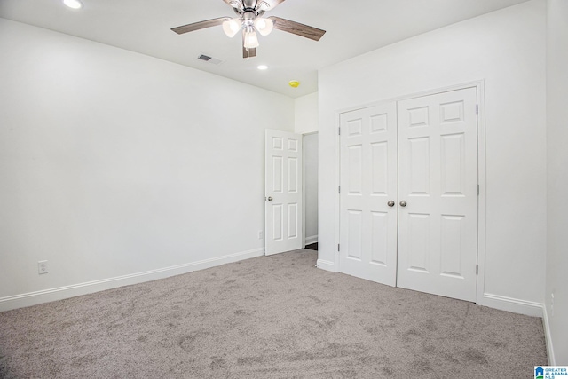 unfurnished bedroom featuring carpet flooring, ceiling fan, and a closet