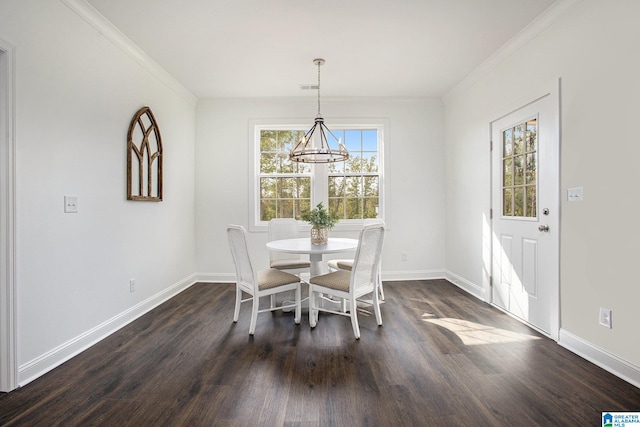 dining room featuring crown molding, dark wood-type flooring, and a chandelier