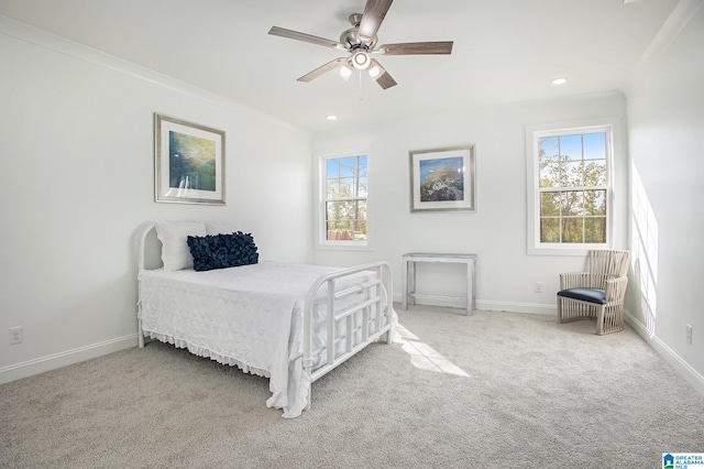 bedroom with ceiling fan, crown molding, and carpet flooring