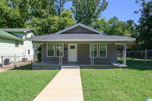 bungalow-style home with a front lawn and covered porch