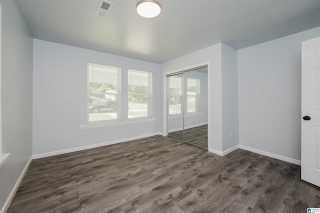 empty room with dark wood-type flooring