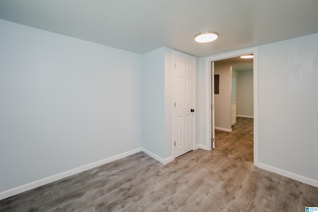 unfurnished room with wood-type flooring