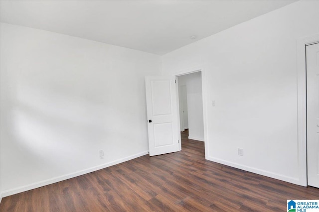 empty room with dark wood-type flooring