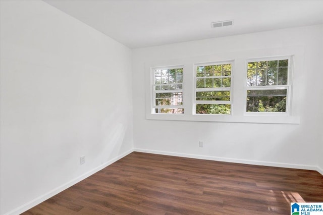 empty room featuring dark hardwood / wood-style flooring