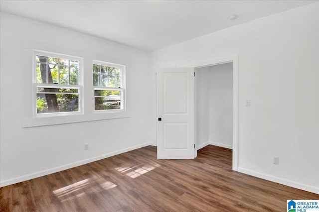 unfurnished room featuring dark hardwood / wood-style floors