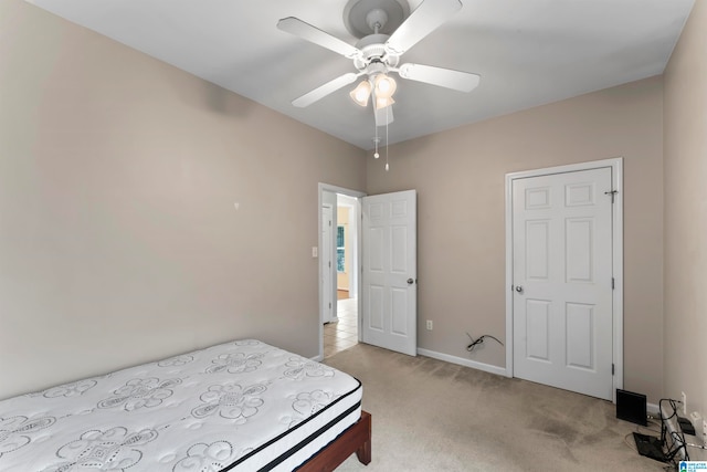 bedroom featuring ceiling fan and light colored carpet