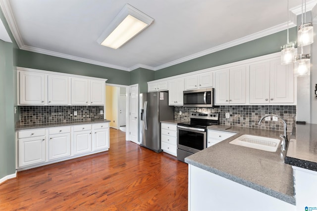 kitchen featuring white cabinets, appliances with stainless steel finishes, and sink