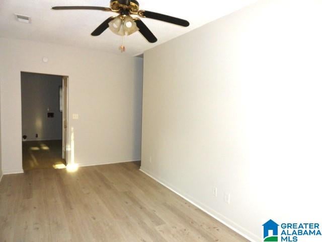 spare room with light wood-type flooring and ceiling fan