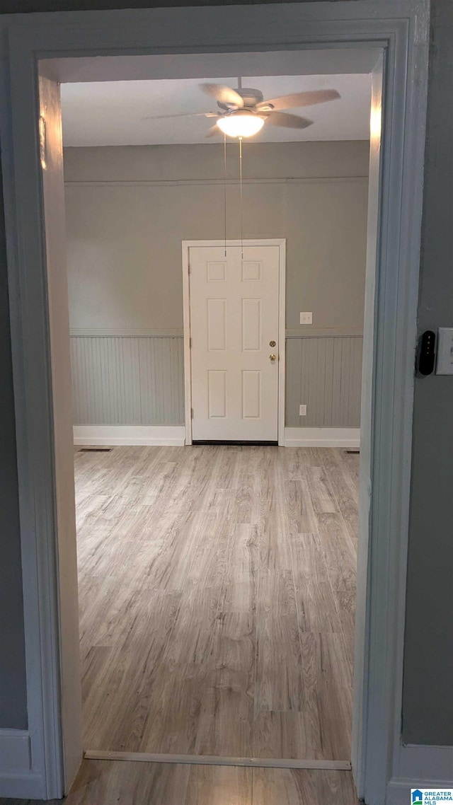 empty room featuring light hardwood / wood-style flooring and ceiling fan