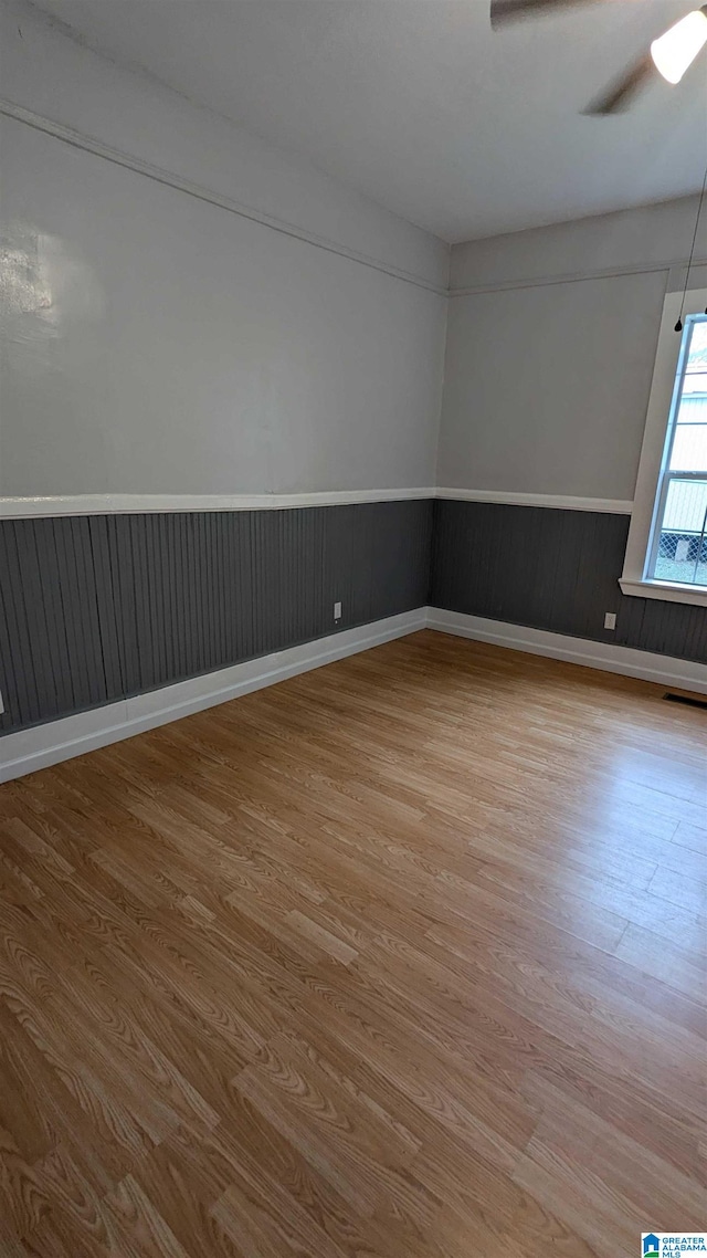 spare room with ceiling fan and light hardwood / wood-style floors