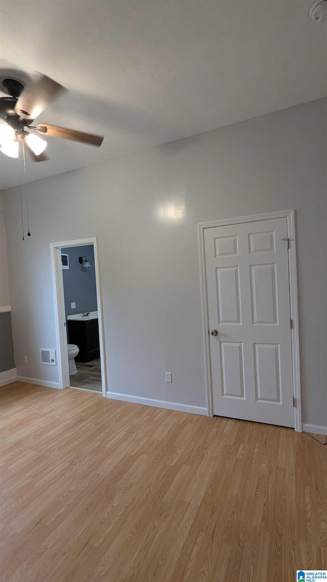 spare room with light wood-type flooring and ceiling fan