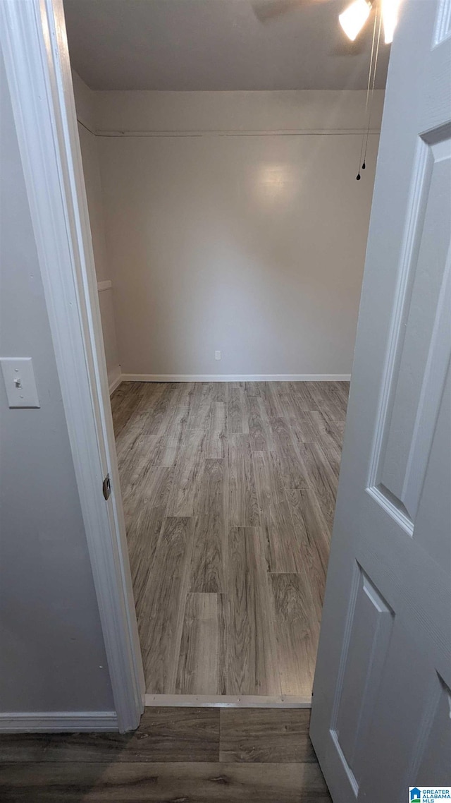 spare room with wood-type flooring and ceiling fan