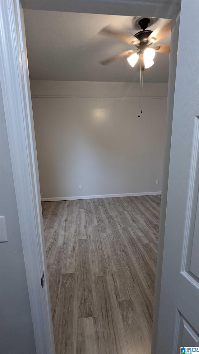 unfurnished room with ceiling fan and light wood-type flooring