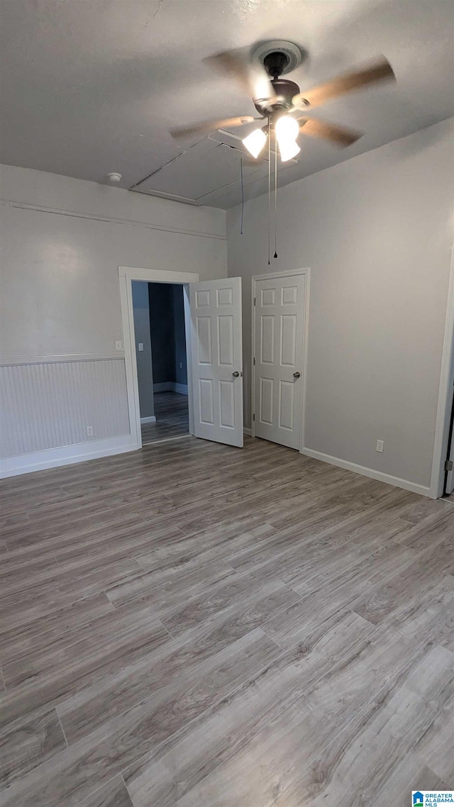 empty room featuring ceiling fan and light hardwood / wood-style floors