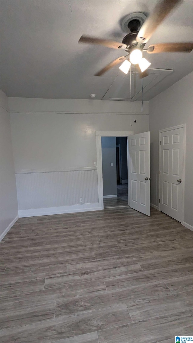 spare room with lofted ceiling, ceiling fan, and light hardwood / wood-style flooring