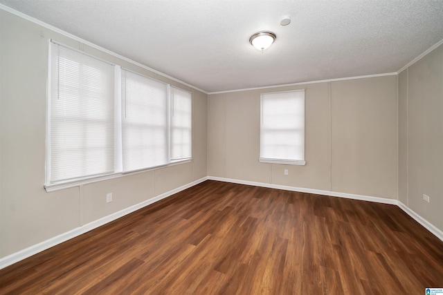 spare room featuring ornamental molding, a textured ceiling, and dark hardwood / wood-style flooring