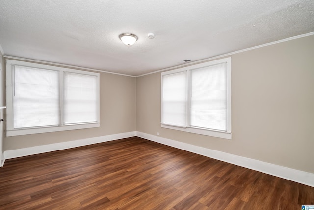 unfurnished room featuring a textured ceiling, crown molding, and dark hardwood / wood-style flooring