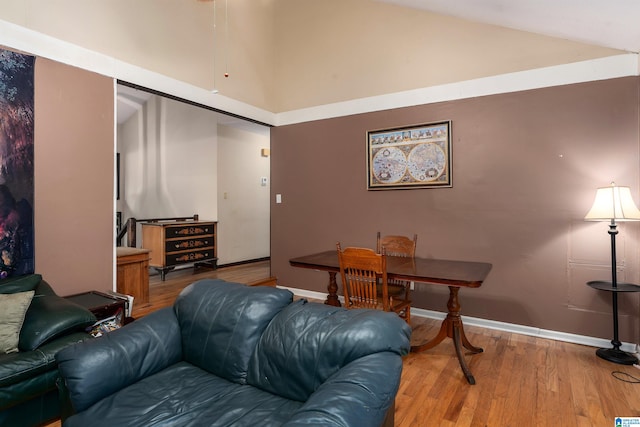 living room with wood-type flooring and vaulted ceiling