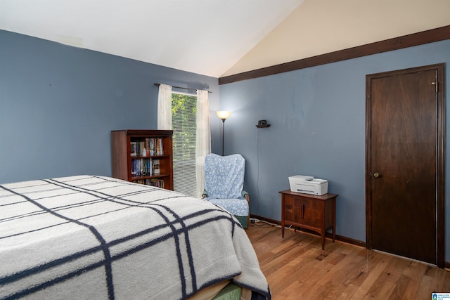 bedroom with light hardwood / wood-style flooring and vaulted ceiling