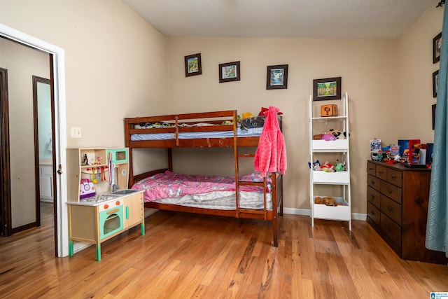 bedroom featuring light hardwood / wood-style flooring and vaulted ceiling