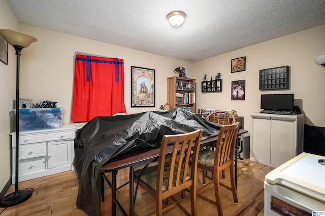 living room with a textured ceiling and wood-type flooring