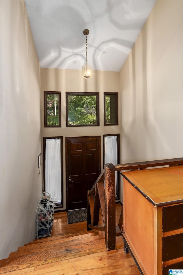 entryway featuring light wood-type flooring and an inviting chandelier