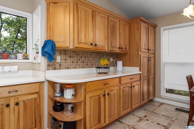 kitchen featuring light tile patterned flooring and tasteful backsplash