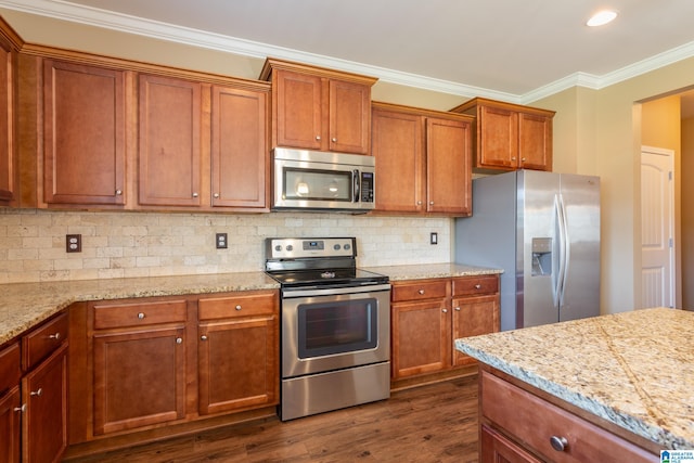 kitchen with crown molding, dark hardwood / wood-style floors, stainless steel appliances, and light stone countertops