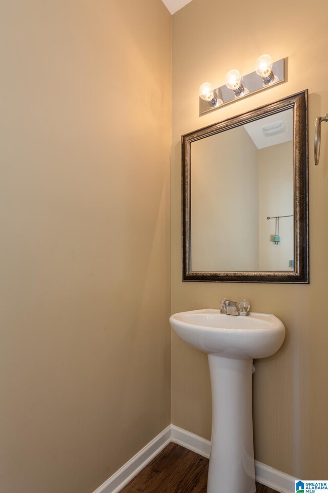 bathroom with hardwood / wood-style flooring