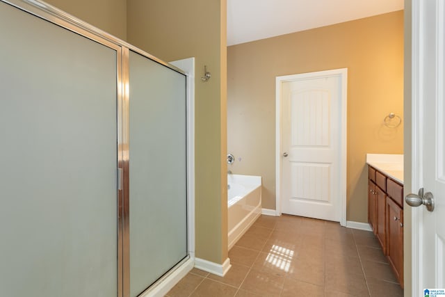 bathroom featuring shower with separate bathtub, tile patterned floors, and vanity