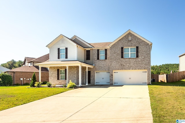 view of front of property featuring a front yard and a garage