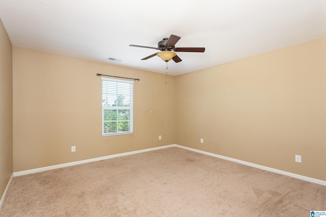 spare room with carpet flooring and ceiling fan