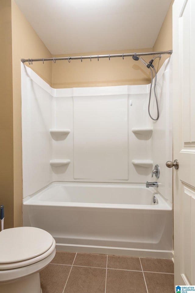 bathroom featuring bathtub / shower combination, tile patterned flooring, and toilet