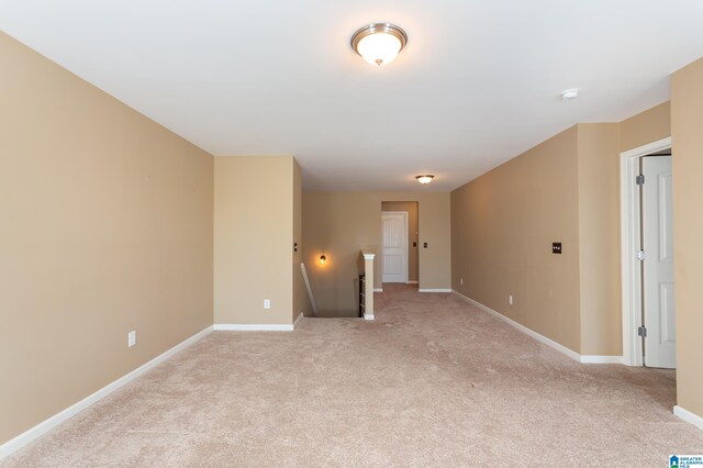 unfurnished room featuring light colored carpet