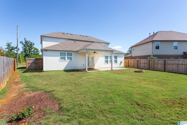 back of house featuring ceiling fan, a yard, and a patio area