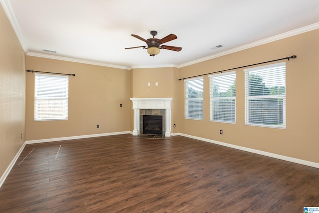 unfurnished living room featuring a healthy amount of sunlight, a fireplace, dark hardwood / wood-style flooring, and ceiling fan