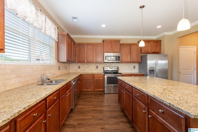 kitchen with dark wood-type flooring, sink, hanging light fixtures, stainless steel appliances, and crown molding