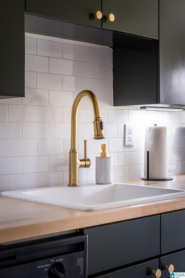 kitchen with dishwashing machine, decorative backsplash, and sink