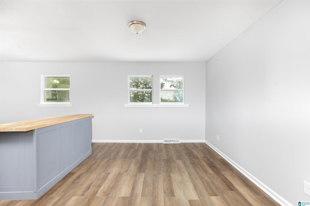 unfurnished room with hardwood / wood-style flooring