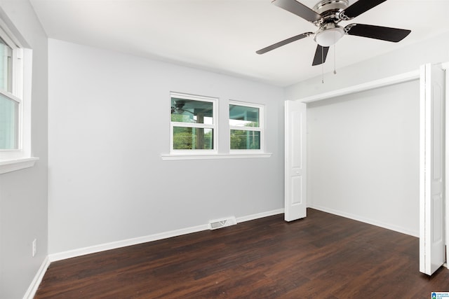 unfurnished bedroom featuring a closet, ceiling fan, and dark hardwood / wood-style floors