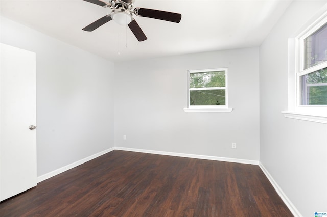 empty room featuring ceiling fan and dark hardwood / wood-style flooring