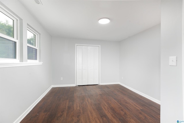 empty room with dark hardwood / wood-style floors