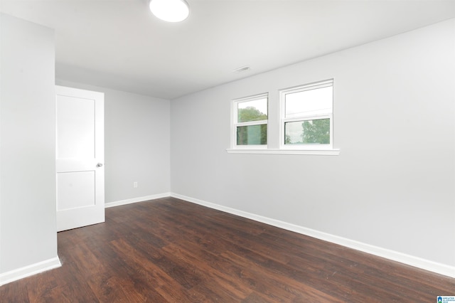 spare room featuring dark wood-type flooring