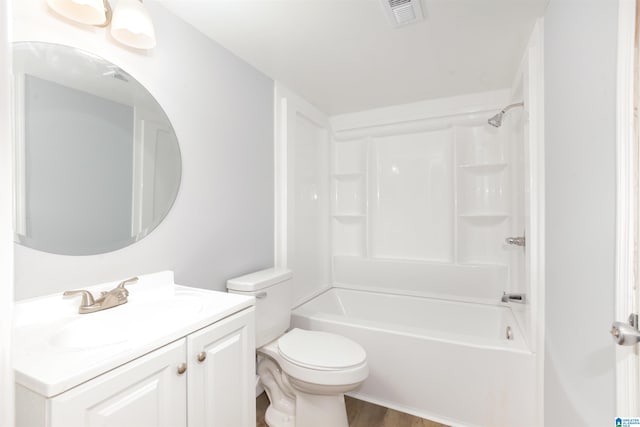 full bathroom featuring wood-type flooring, tub / shower combination, vanity, and toilet