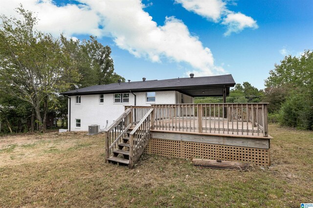 back of house with a lawn, a deck, and central air condition unit