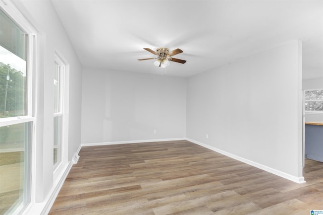 unfurnished room with ceiling fan and light wood-type flooring