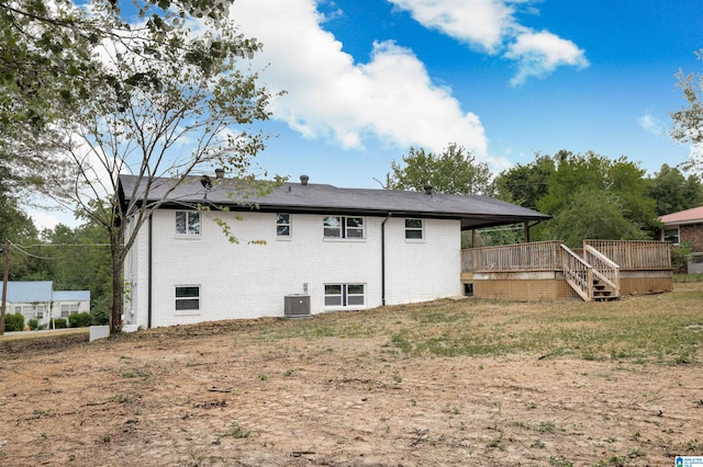 back of house with central AC unit and a wooden deck