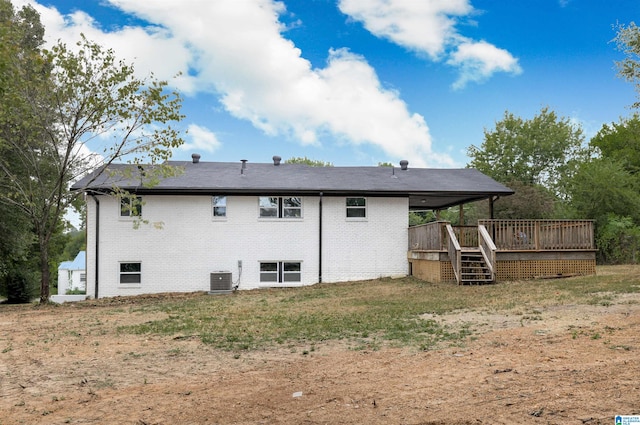 back of property with central AC unit and a deck