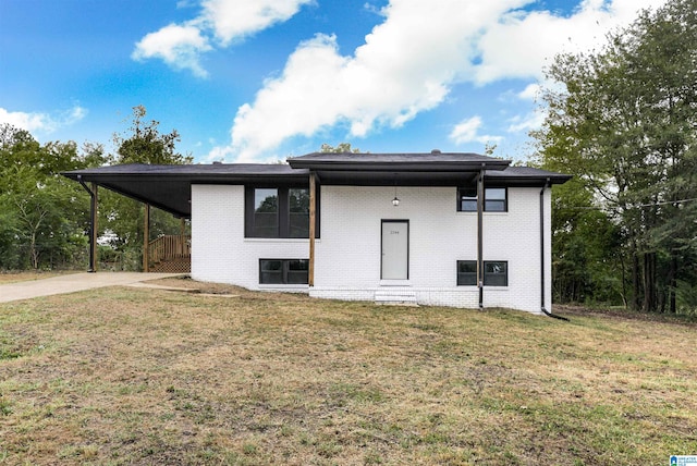 exterior space with a carport and a yard